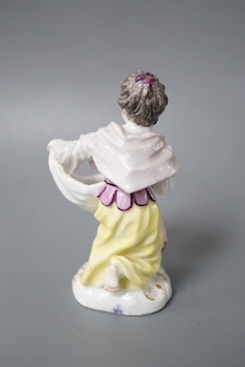 An 18th century Meissen figure of a girl holding her apron to make a basket shape kneeling on the mound scroll moulded base, small crossed swords in blue on the backside of the base. 9.5cm